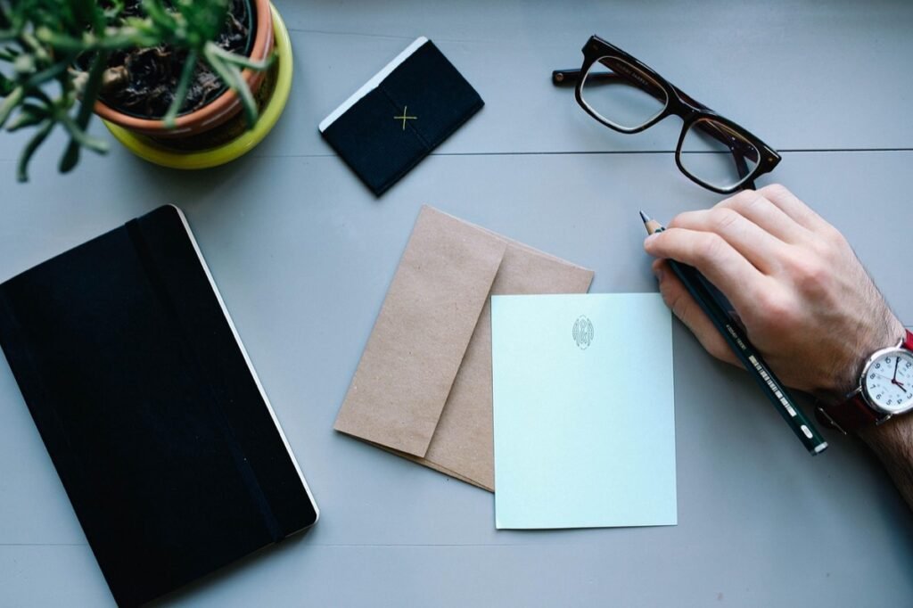 Notebook, envelope and glasses on a desk