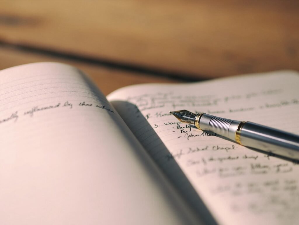 Fountain pen writing notes in an open notebook